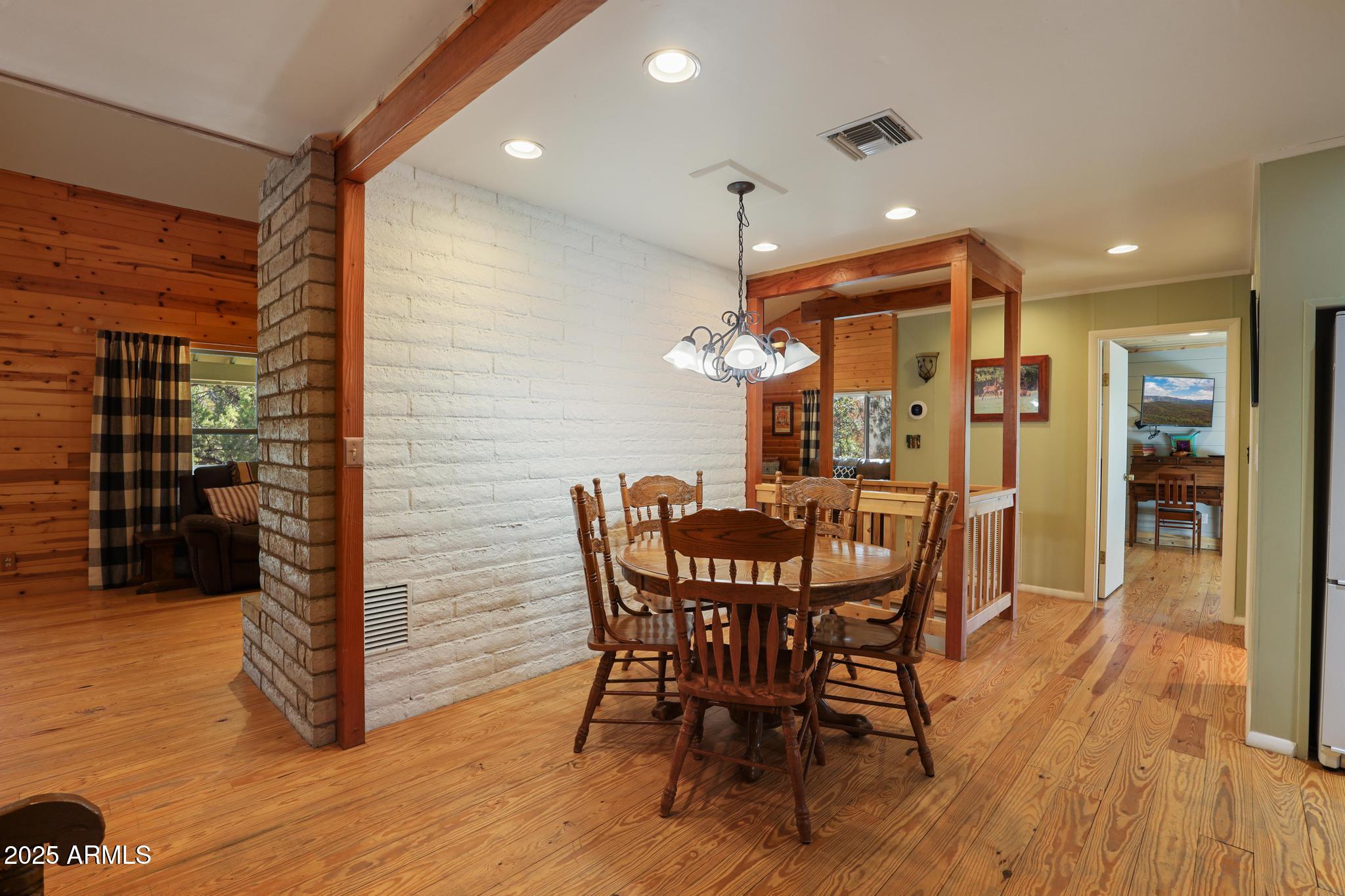 4744 Charles Circle Strawberry, AZ 85544 - Photo 10 of 39 a view of a dining room with furniture and wooden floor