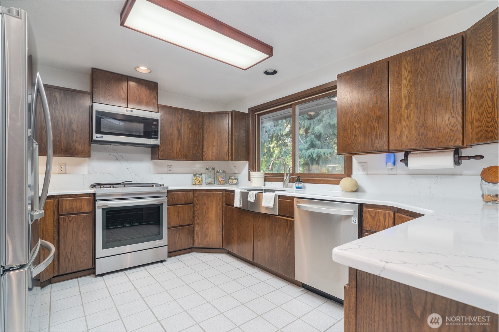 2102 Mark Street Northeast Olympia, WA 98516 - Photo 15 of 37 a kitchen with stainless steel appliances granite countertop a stove sink and cabinets