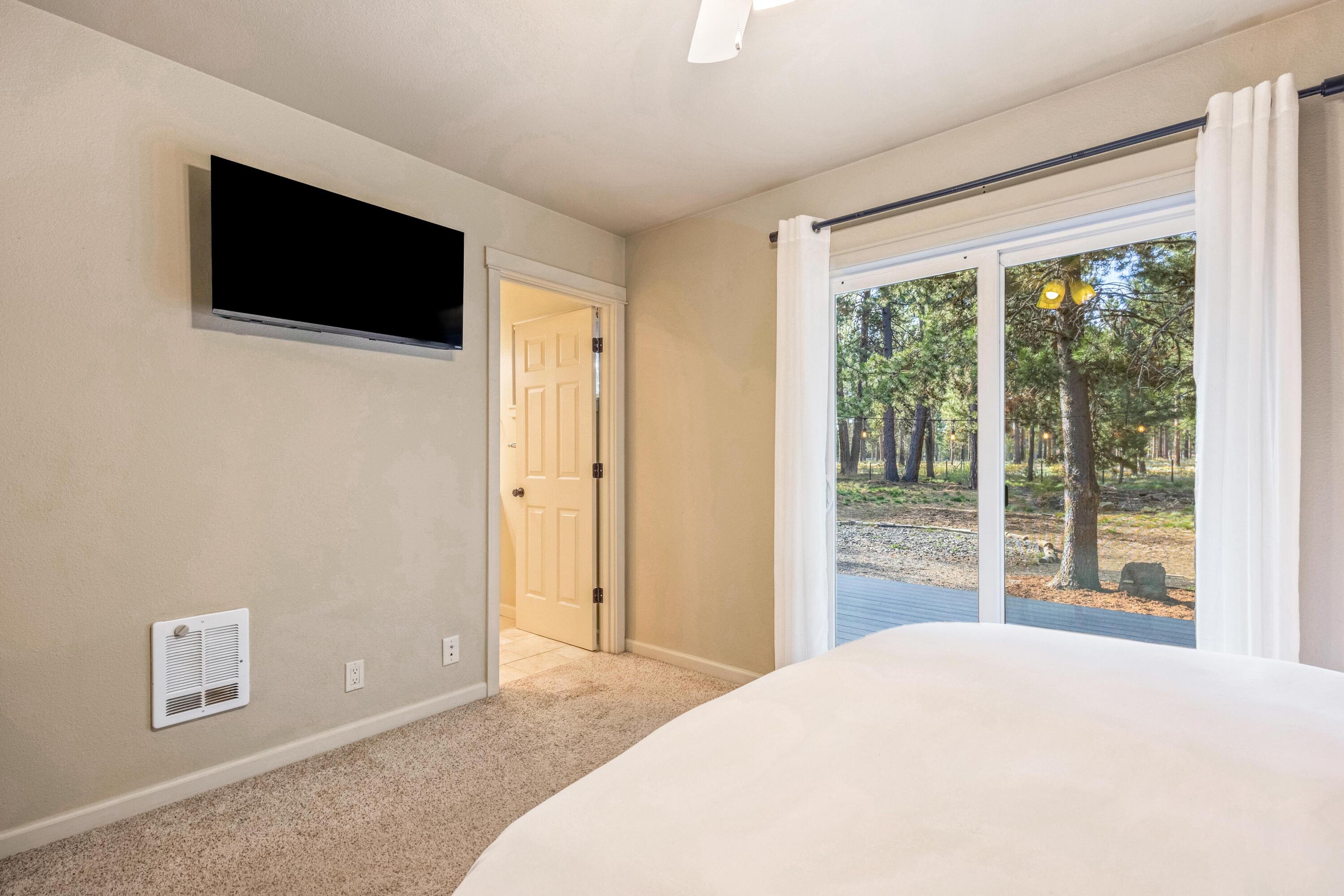 16983 Jacinto Road Bend, OR 97707 - Photo 11 of 29 a bedroom with a bed and a flat screen tv