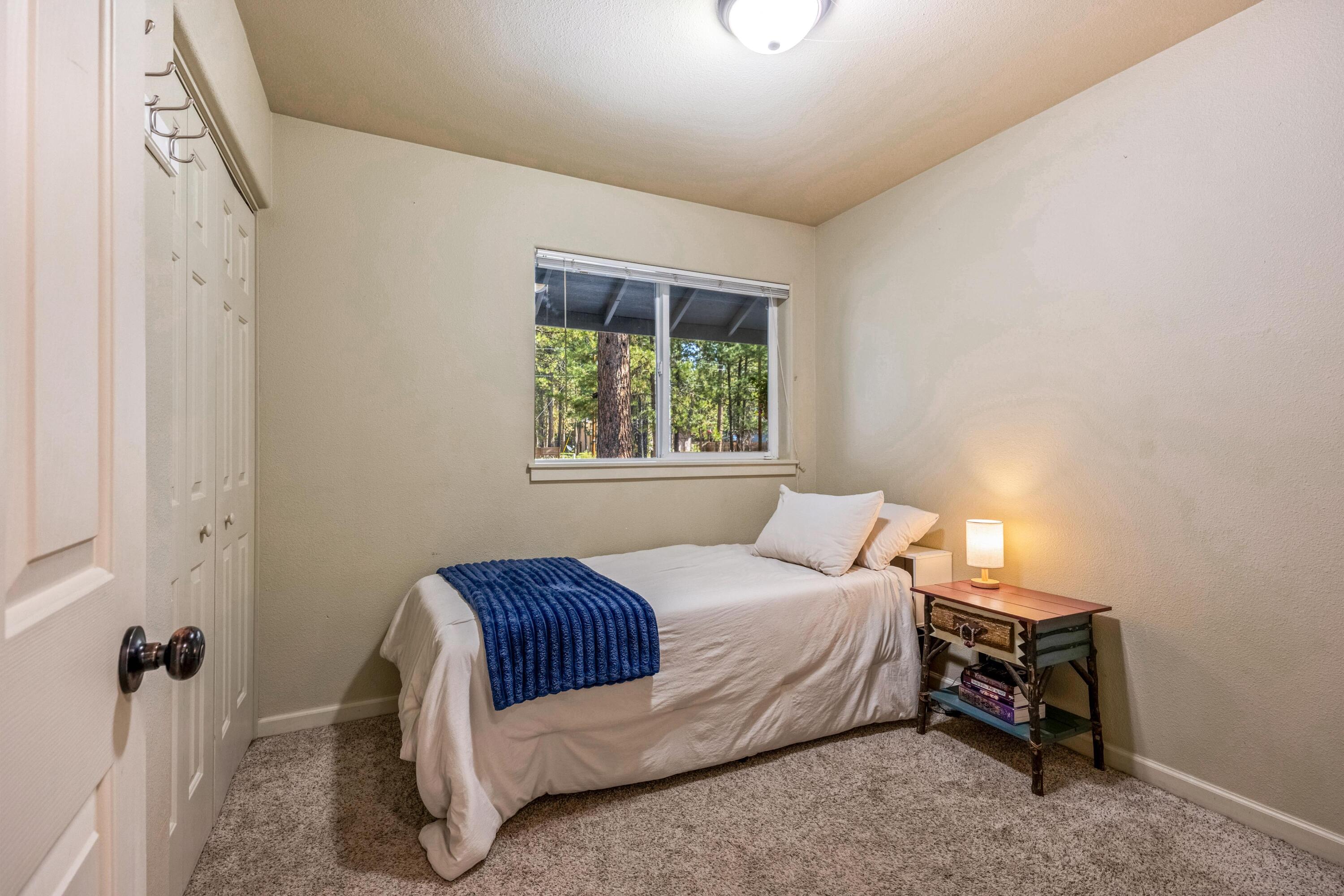16983 Jacinto Road Bend, OR 97707 - Photo 15 of 29 a bedroom with a bed and a window