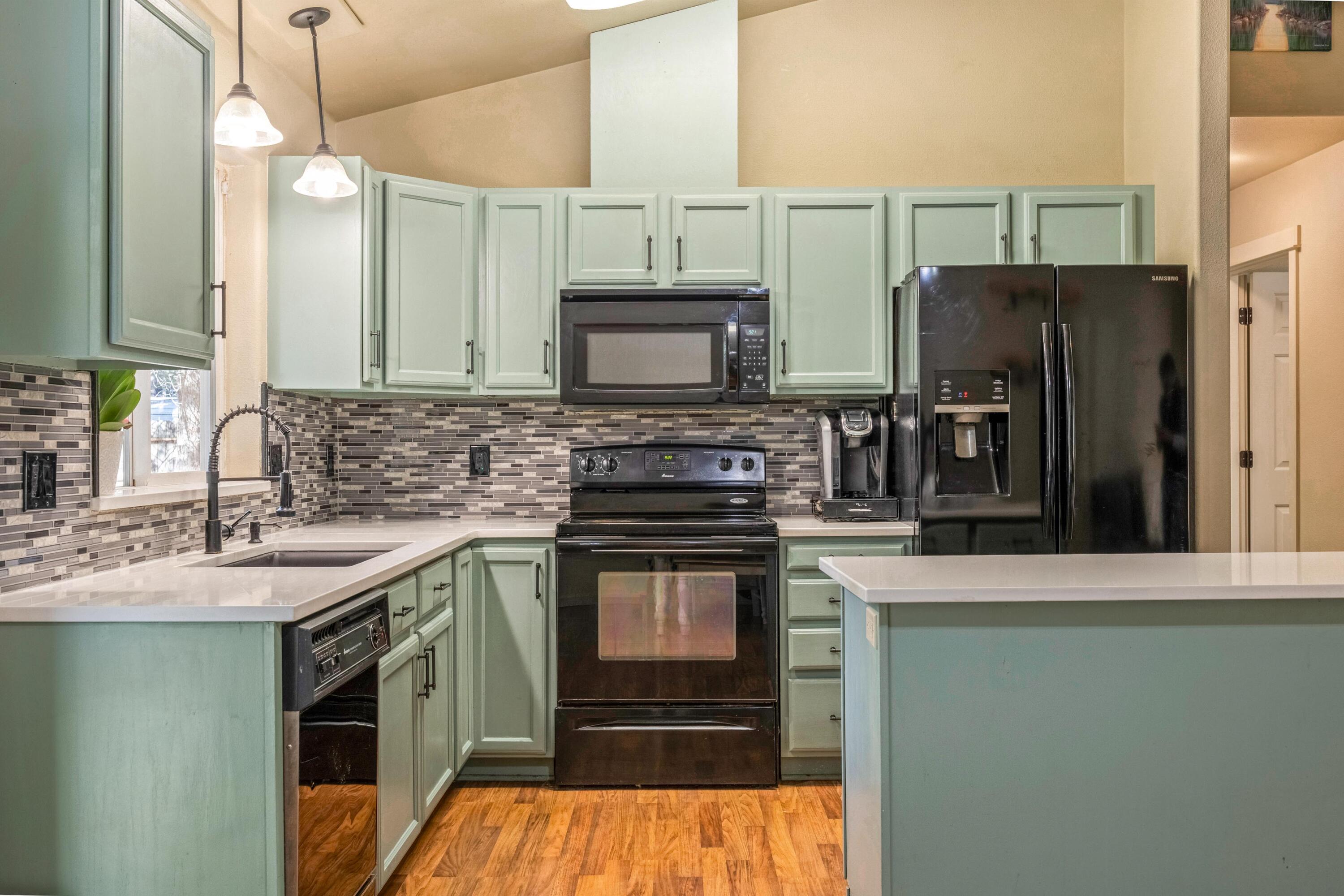 16983 Jacinto Road Bend, OR 97707 - Photo 3 of 29 a kitchen with stainless steel appliances granite countertop a sink stove and refrigerator