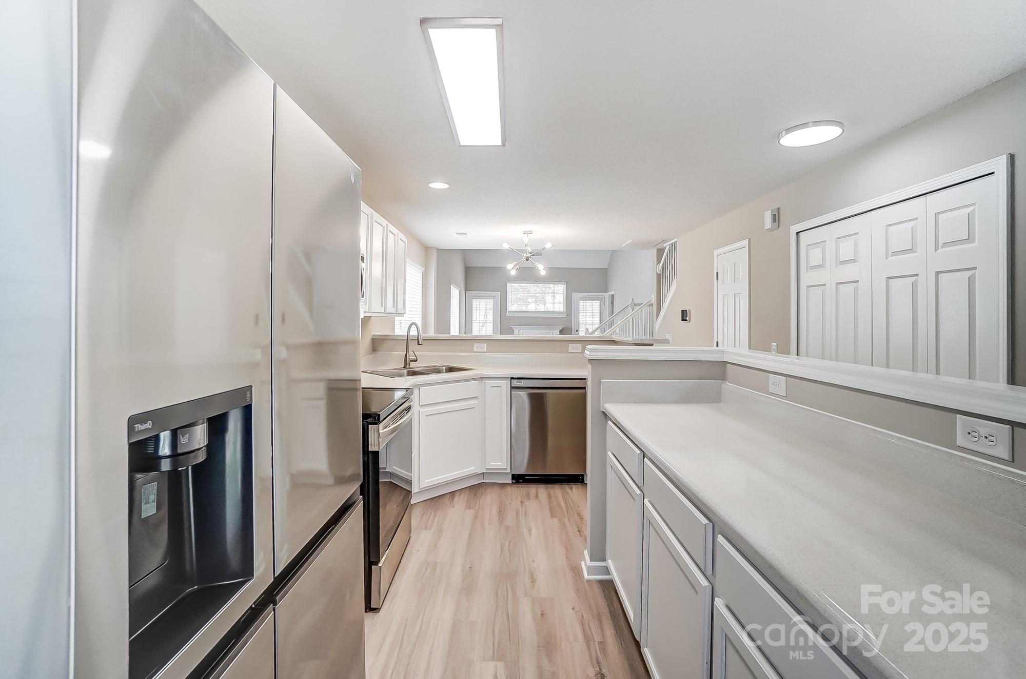 16729 Timber Crossing Road Charlotte, NC 28213 - Photo 12 of 48 a kitchen with a sink a counter top space stainless steel appliances and cabinets