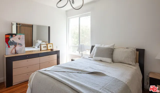a bedroom with a large bed and a large window