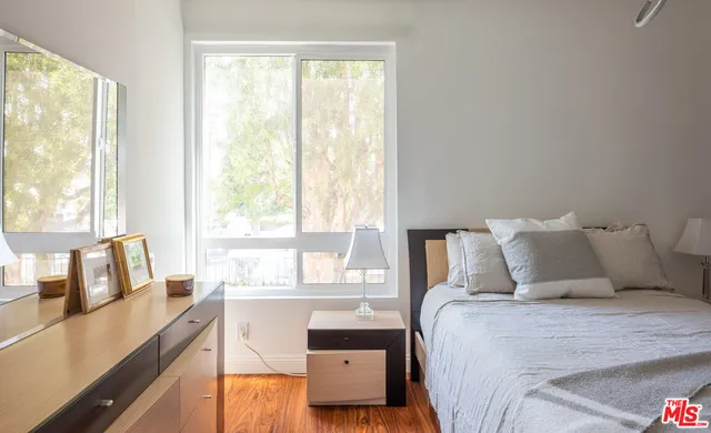 a bedroom with a large bed and a large window