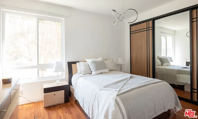 a bedroom with a large bed and a window