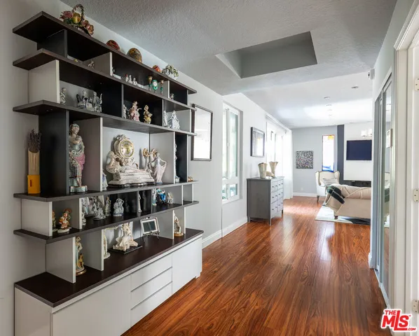 a view of a living room with furniture and wooden floor