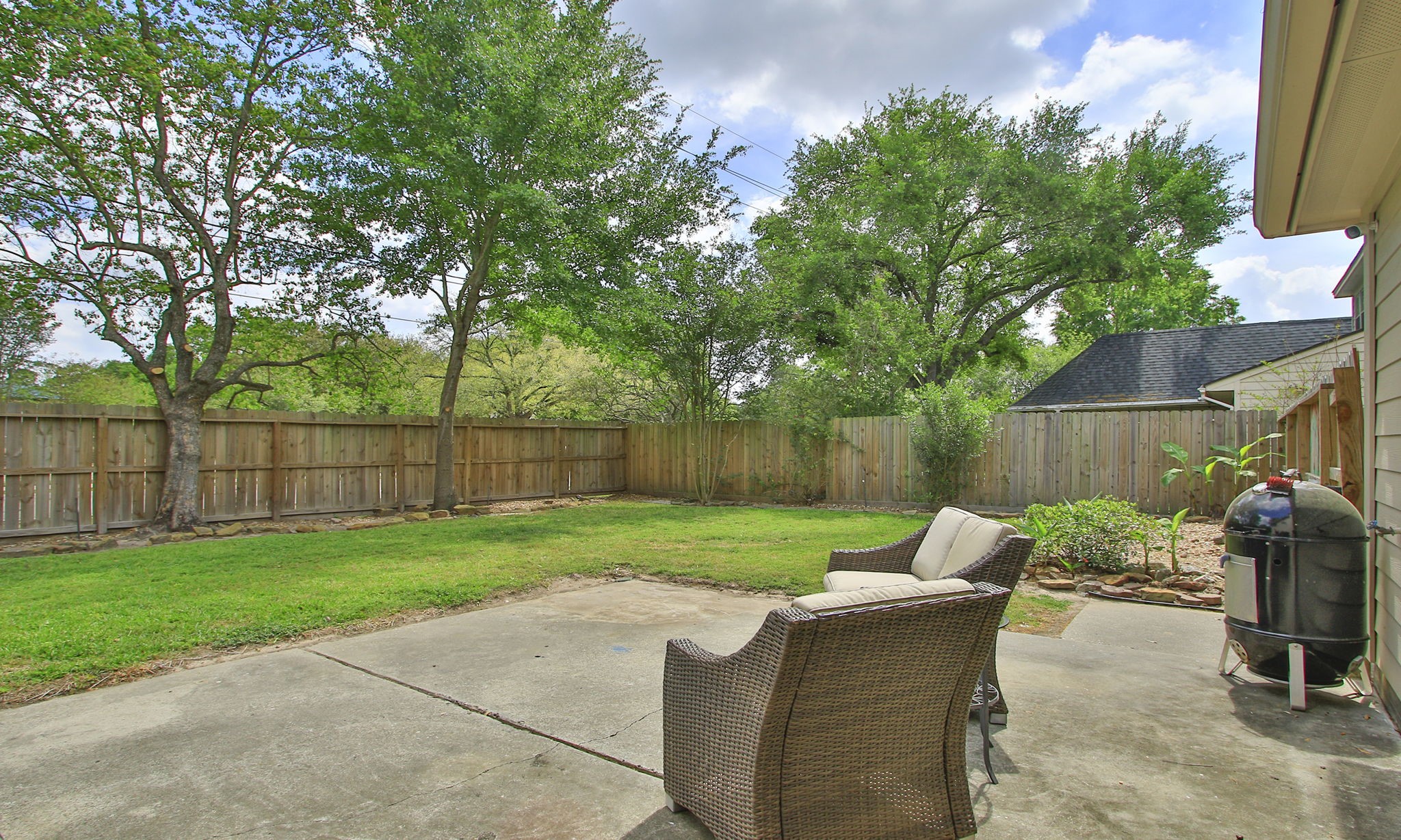 17618 Hidden Forest Drive Spring, TX 77379 - Photo 41 of 49 a view of a backyard with table and chairs potted plants and a palm tree