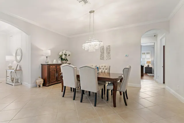 a living room with patio furniture and a floor to ceiling window
