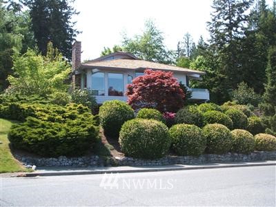 113 Bayside Road Bellingham, WA 98225 - Photo 1 of 1 a view of a garden filled with plants and large tree