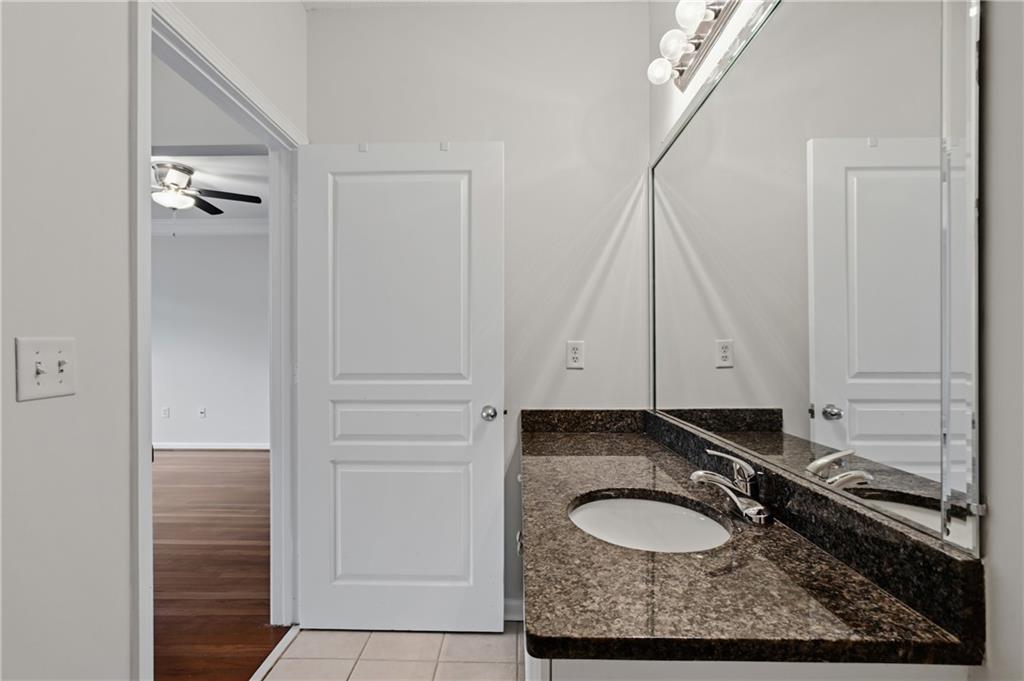 10 Perimeter Summit Boulevard, Unit 3311 Atlanta, GA 30319 - Photo 67 of 68 a bathroom with a granite countertop sink and a mirror