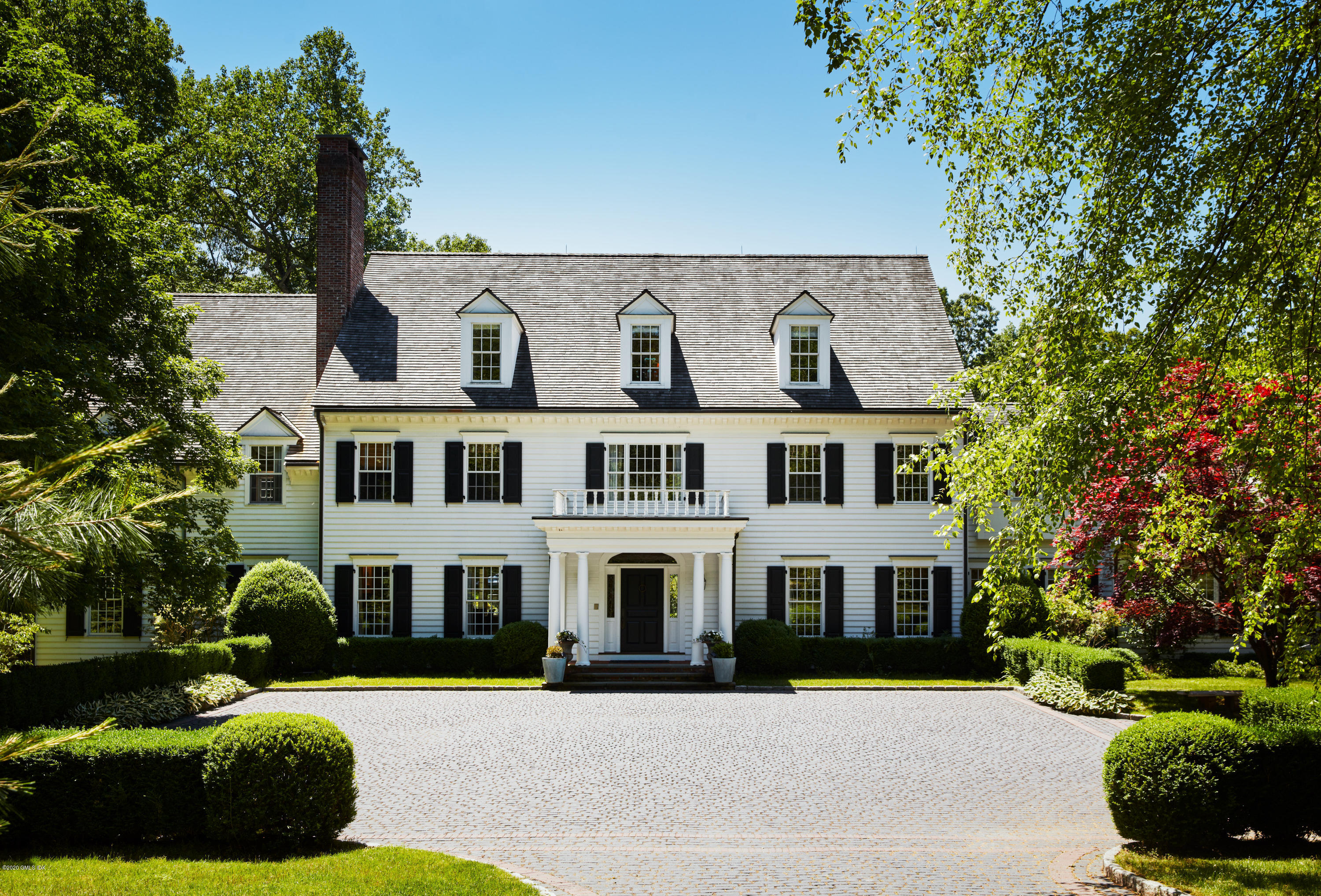 74 Upper Cross Road Greenwich, CT 06831 - Photo 1 of 20 a front view of a residential apartment building with a yard