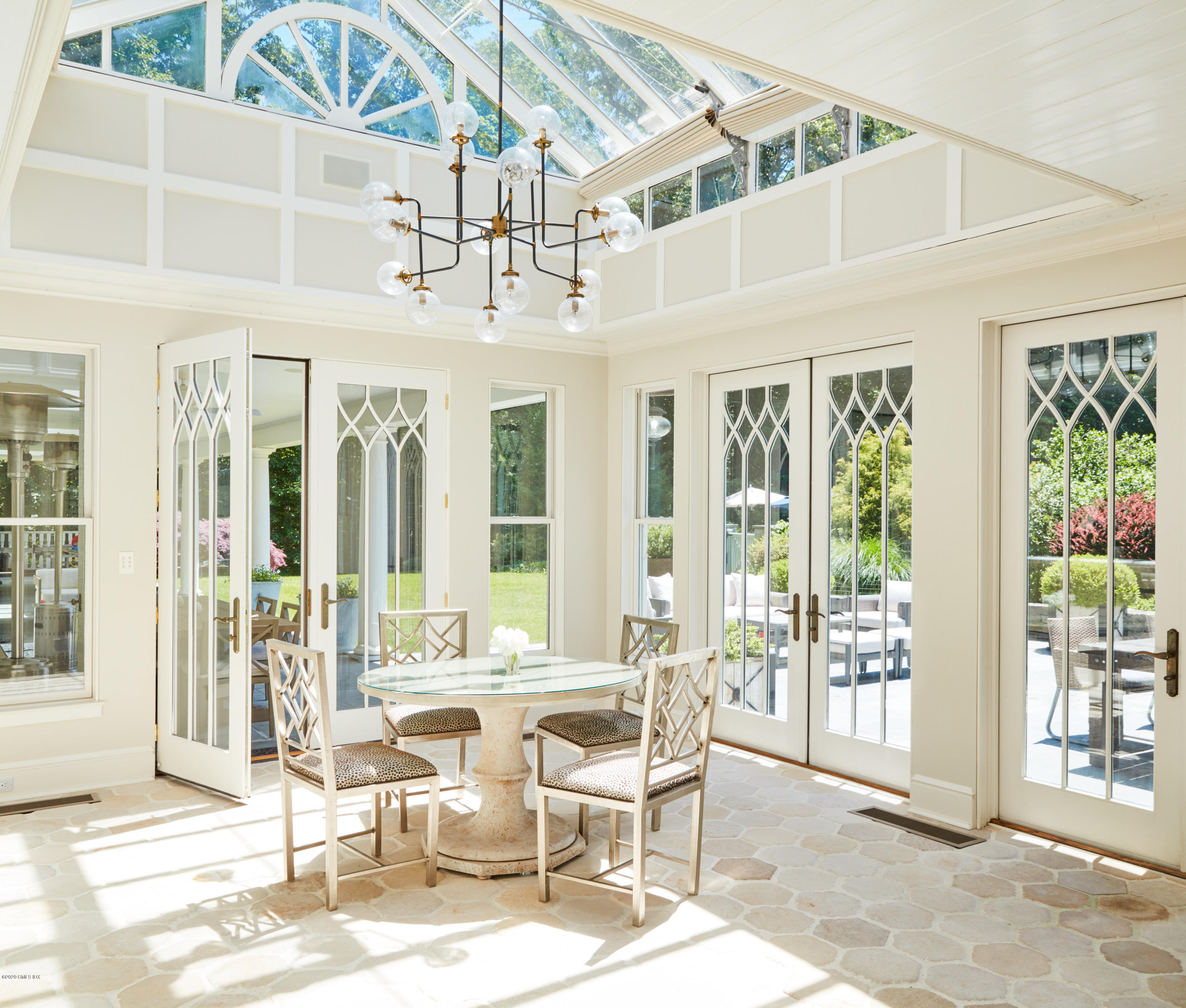 74 Upper Cross Road Greenwich, CT 06831 - Photo 8 of 20 a dining room with wooden floor and large windows