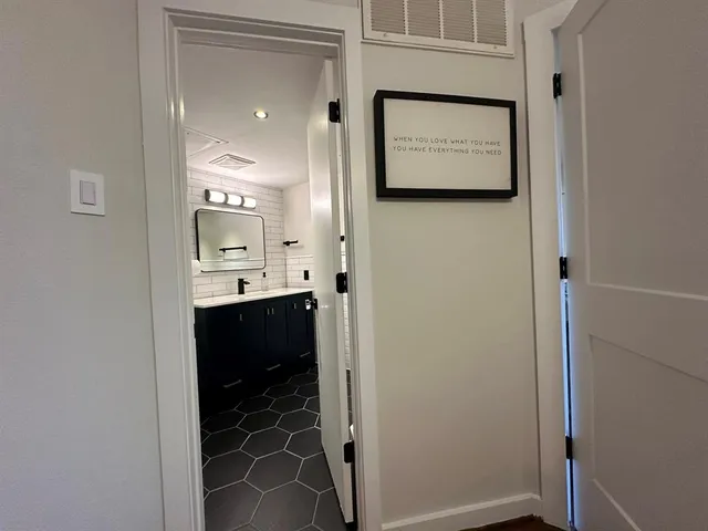 a bathroom with a sink toilet and mirror