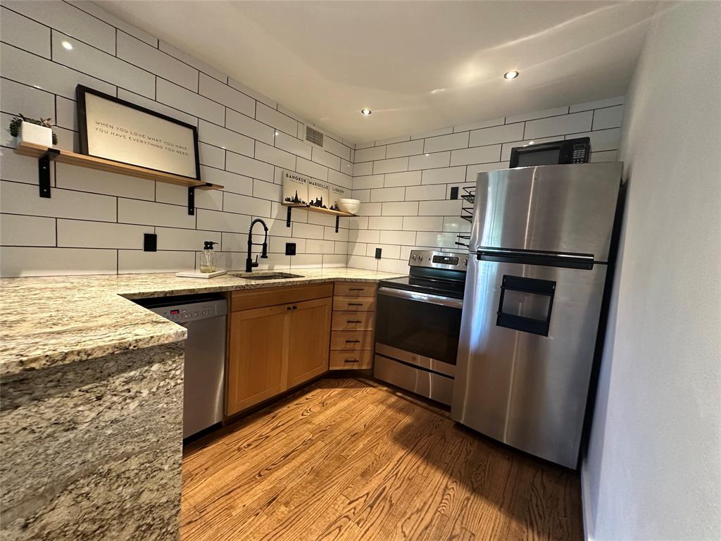 18333 Roehampton Drive, Unit 1524 Dallas, TX 75252 - Photo 21 of 21 a kitchen with a sink a refrigerator and cabinets