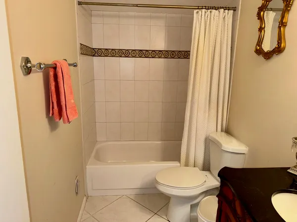 a white toilet sitting next to a bathroom sink