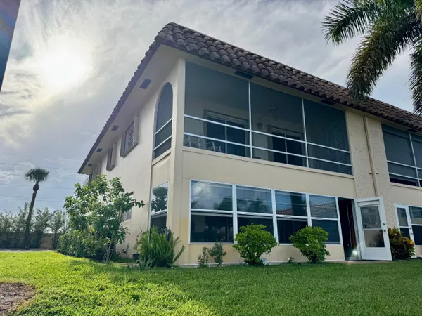 a view of a house with a yard and plants