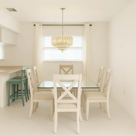a view of a dining room with furniture and a chandelier