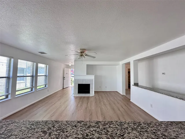 wooden floor in an empty room with a fireplace
