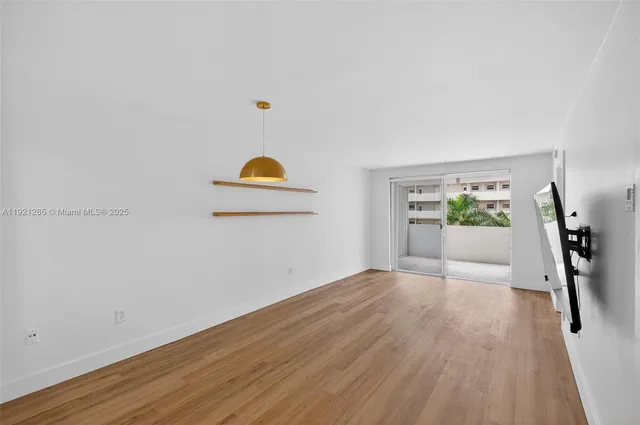 a view of a hallway with wooden floor and workspace