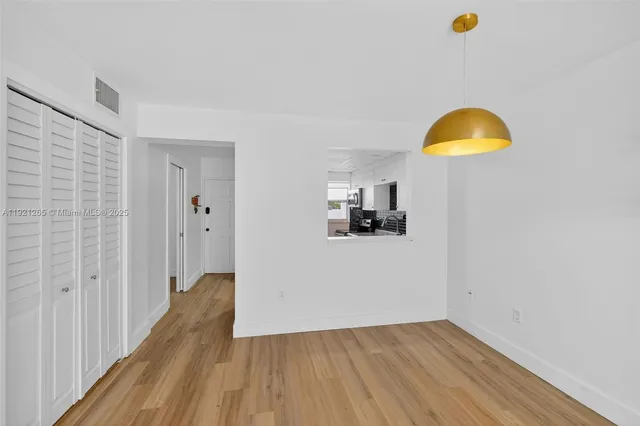 a view of a room with wooden floor and sink