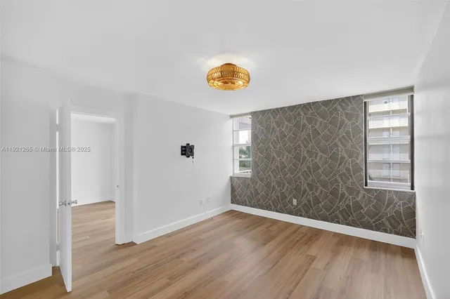 a view of a room with wooden floor and window