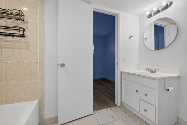 a spacious bathroom with a sink and a mirror