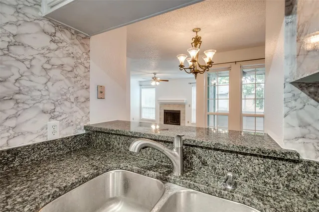 a bathroom with a granite countertop sink a large mirror and a shower