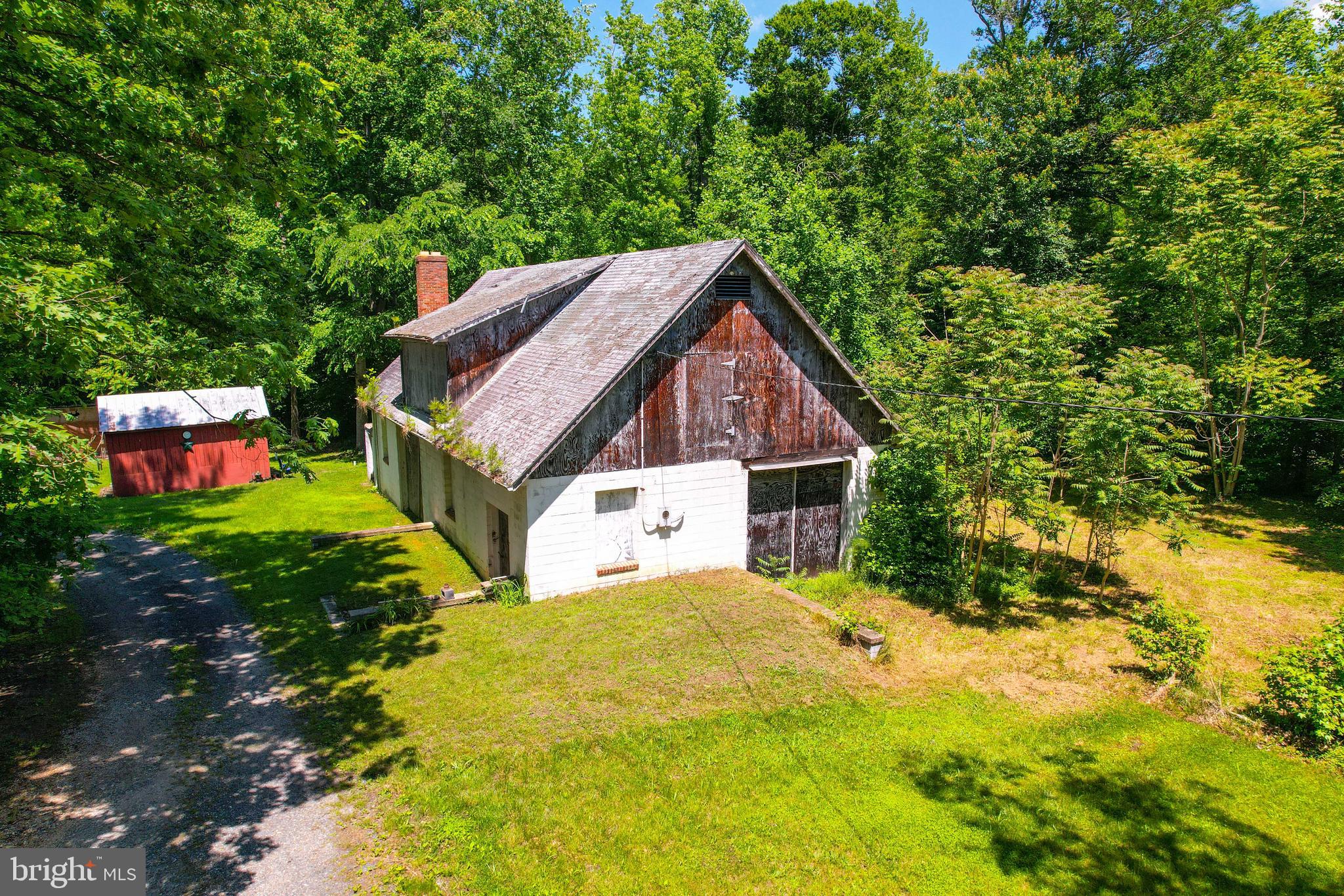 5709 Plummer Lane Lothian, MD 20711 - Photo 14 of 15 a view of a house with a large tree and a yard