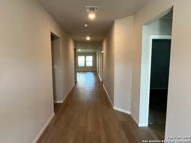 a view of hallway with wooden floor
