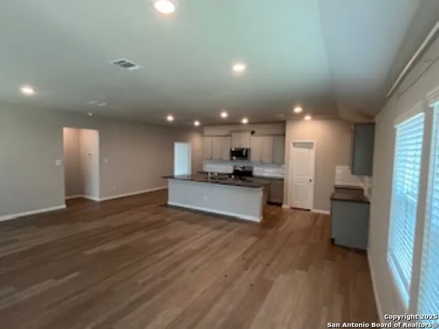 a view of kitchen with refrigerator sink and stove