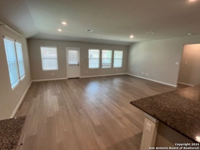 32132 Morels Avenue Bulverde, TX 78163 - Photo 9 of 13 an empty room with wooden floor and windows