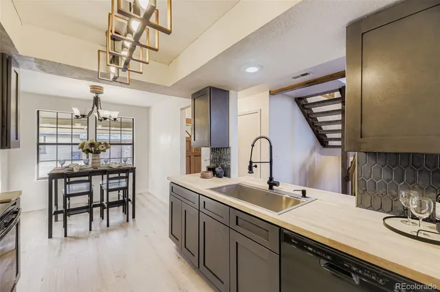 a kitchen with a sink and chairs
