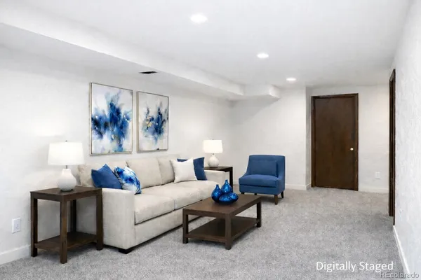a living room with furniture and a lamp
