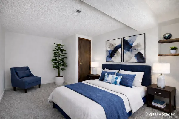 a bedroom with a bed and a couch