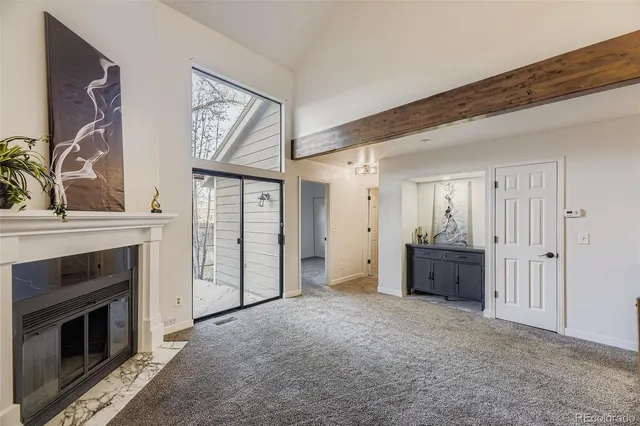 a view of a livingroom with an empty space and a fireplace