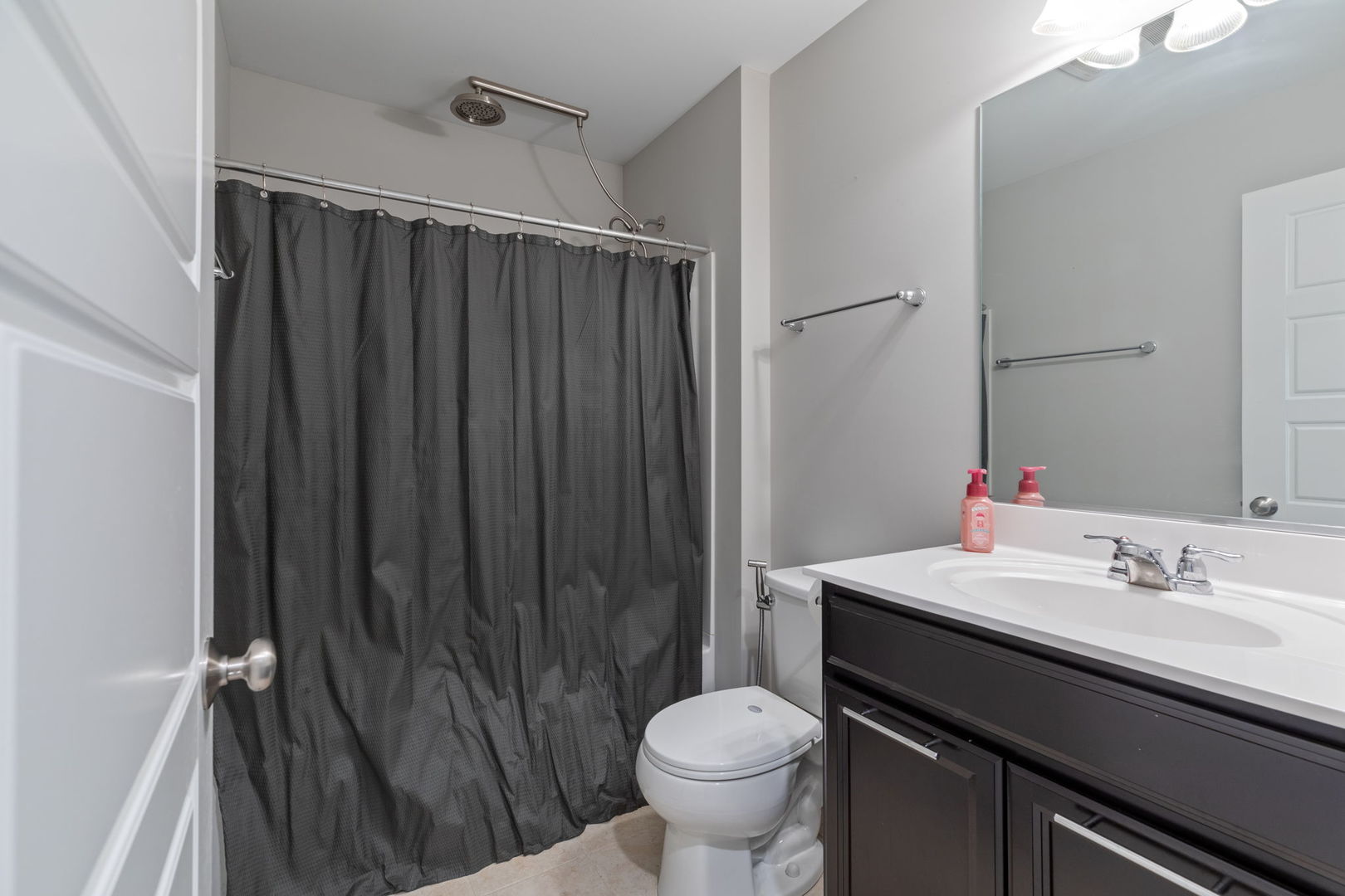 993 Times Square Drive Aurora, IL 60504 - Photo 19 of 26 a bathroom with a sink a toilet a mirror and shower curtain