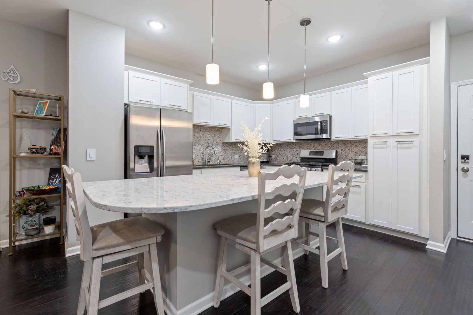 993 Times Square Drive Aurora, IL 60504 - Photo 8 of 26 a kitchen with stainless steel appliances a table chairs refrigerator and microwave