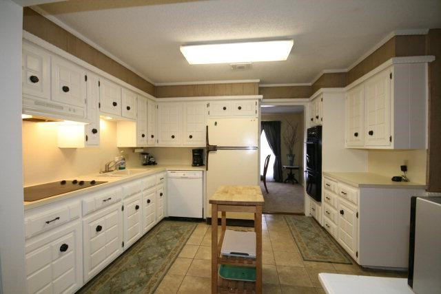 3802 70th Street Lubbock, TX 79413 - Photo 4 of 10 a large white kitchen with cabinets