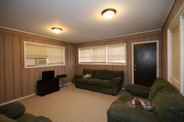 3802 70th Street Lubbock, TX 79413 - Photo 7 of 10 a living room with furniture window and a flat screen tv