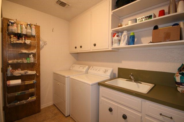 3802 70th Street Lubbock, TX 79413 - Photo 8 of 10 a utility room with dryer and washer