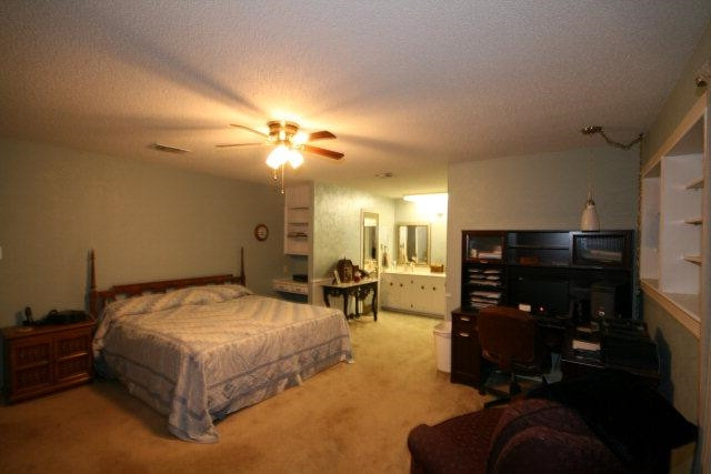 3802 70th Street Lubbock, TX 79413 - Photo 9 of 10 a bedroom with a bed and ceiling fan