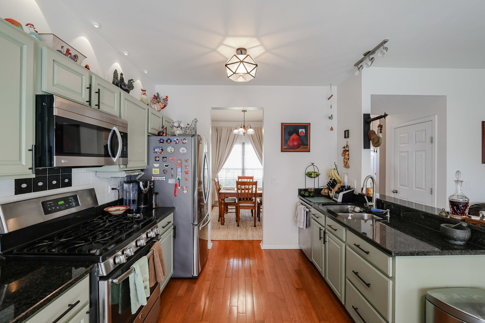 7 Michael Court Lake In The Hills, IL 60156 - Photo 8 of 37 a kitchen with granite countertop a sink stove and cabinets