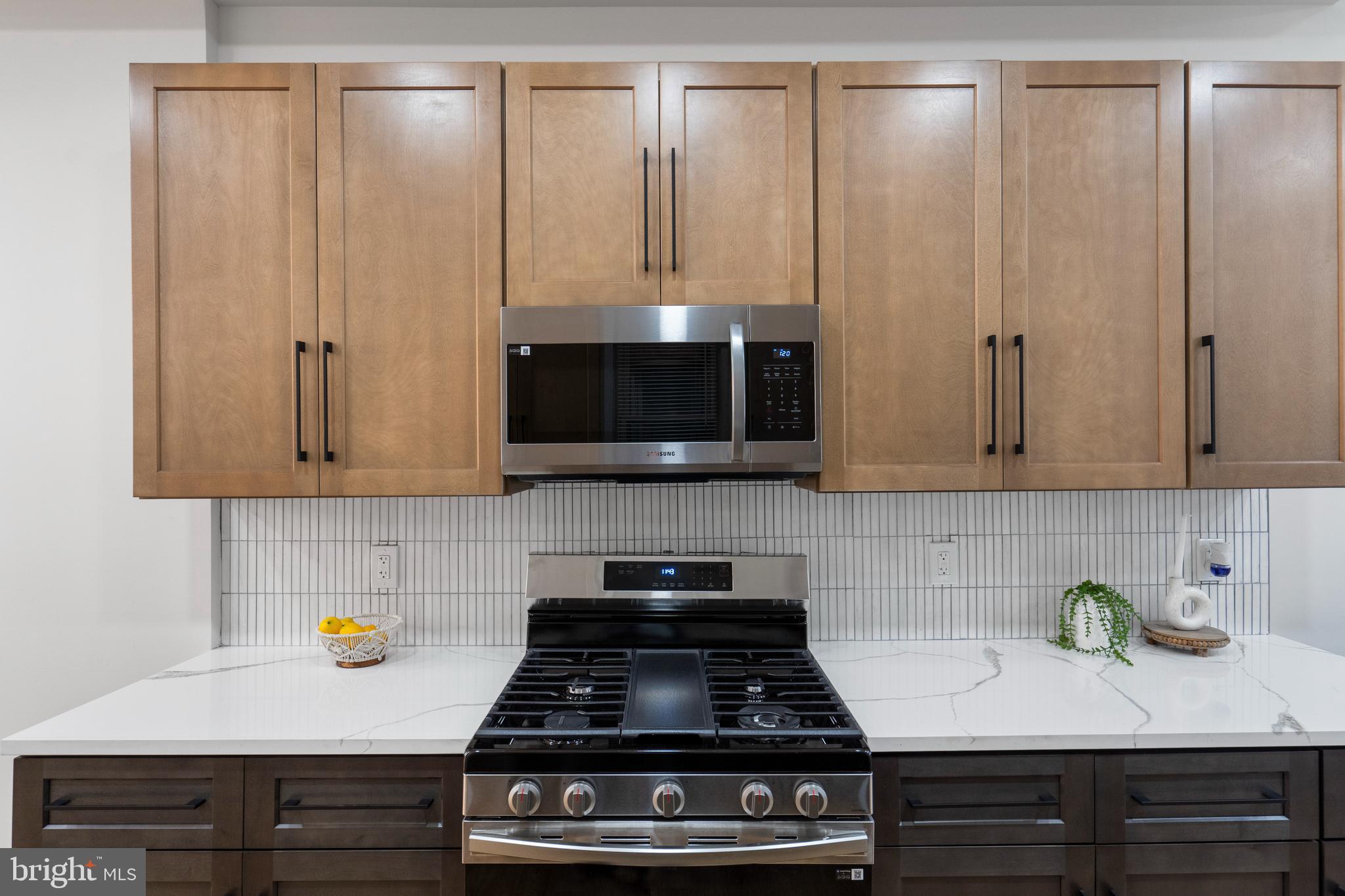 2237 Madison Avenue Baltimore, MD 21217 - Photo 19 of 53 a kitchen with stainless steel appliances a stove and a microwave