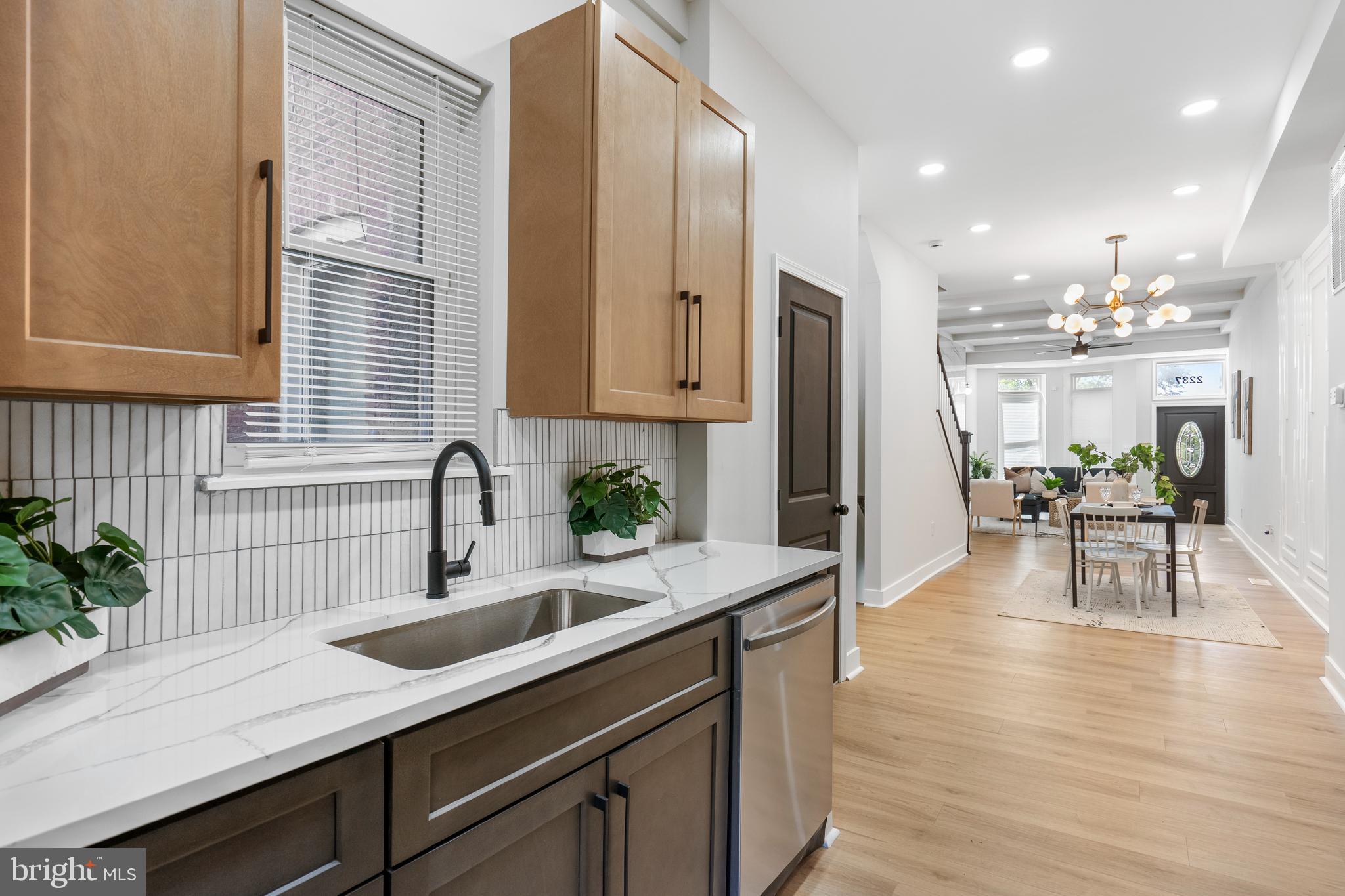 2237 Madison Avenue Baltimore, MD 21217 - Photo 20 of 53 a kitchen with stainless steel appliances granite countertop sink stove refrigerator and cabinets