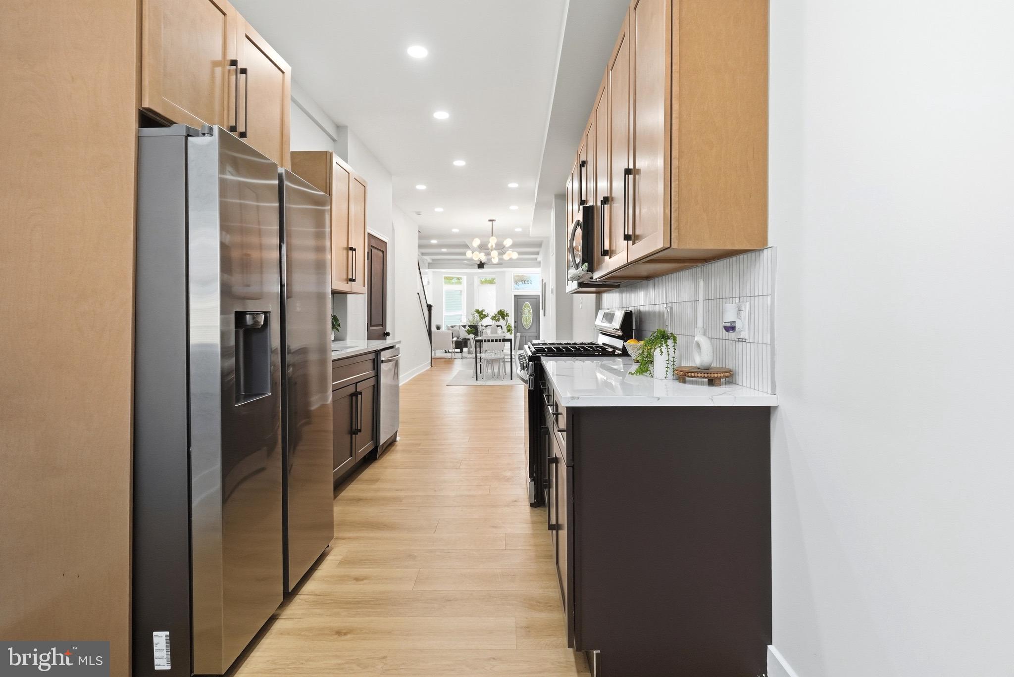 2237 Madison Avenue Baltimore, MD 21217 - Photo 21 of 53 a kitchen with stainless steel appliances granite countertop a refrigerator and a sink