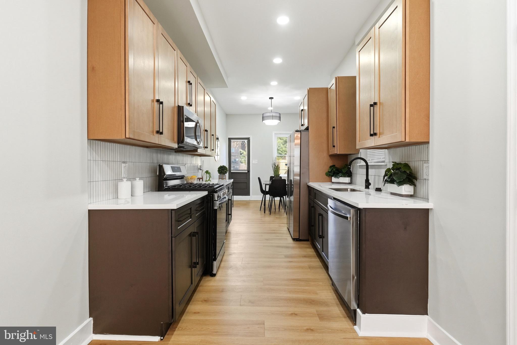 2237 Madison Avenue Baltimore, MD 21217 - Photo 22 of 53 a large kitchen with stainless steel appliances lots of counter space and a sink