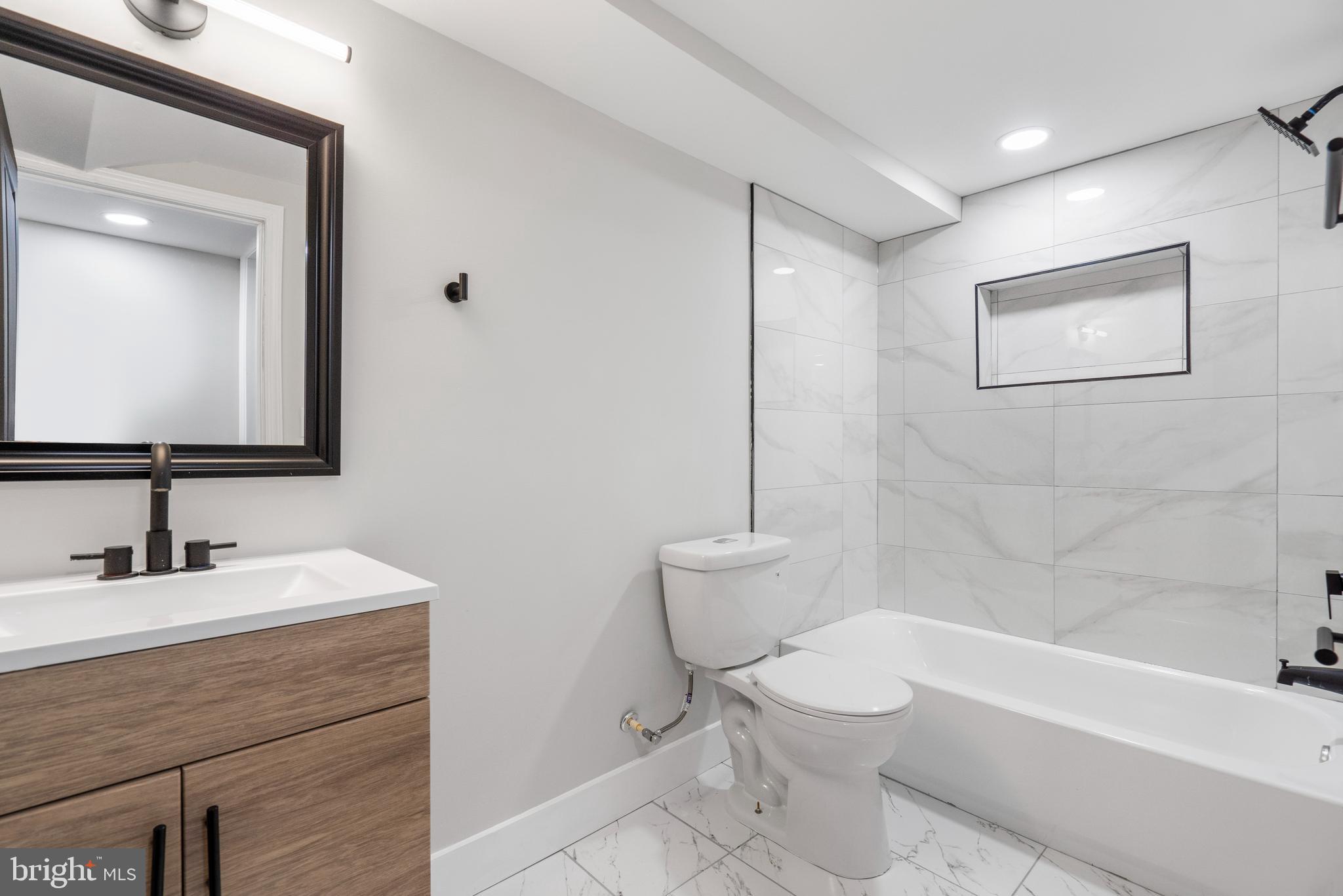 2237 Madison Avenue Baltimore, MD 21217 - Photo 30 of 53 a bathroom with a toilet a sink and bathtub