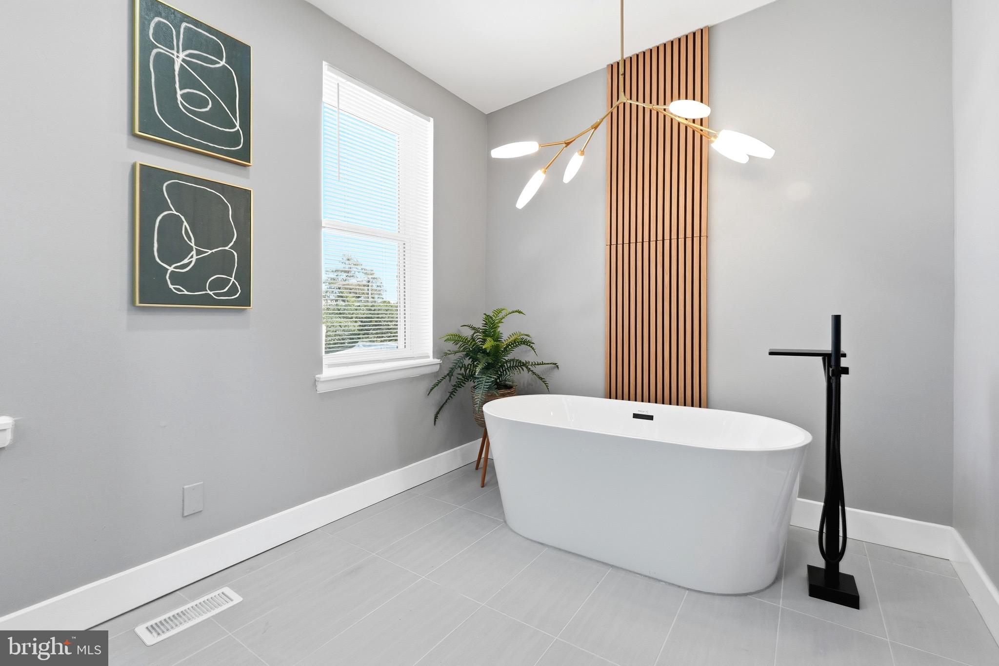 2237 Madison Avenue Baltimore, MD 21217 - Photo 36 of 53 a white bath tub sitting next to a white cabinet