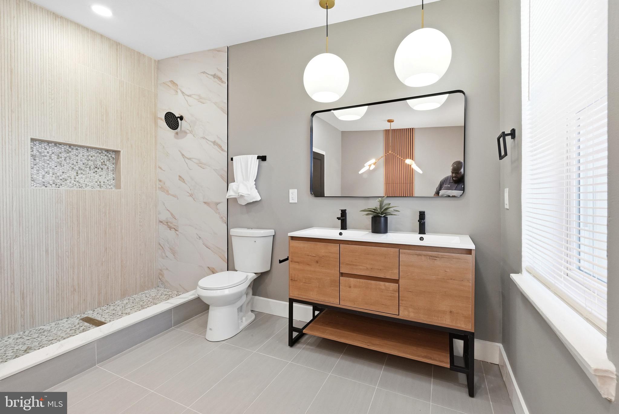 2237 Madison Avenue Baltimore, MD 21217 - Photo 39 of 53 a bathroom with a double vanity sink toilet and a mirror