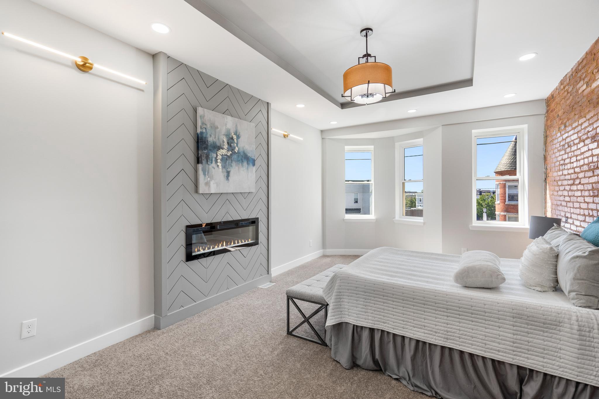 2237 Madison Avenue Baltimore, MD 21217 - Photo 43 of 53 a bedroom with a bed and a chandelier